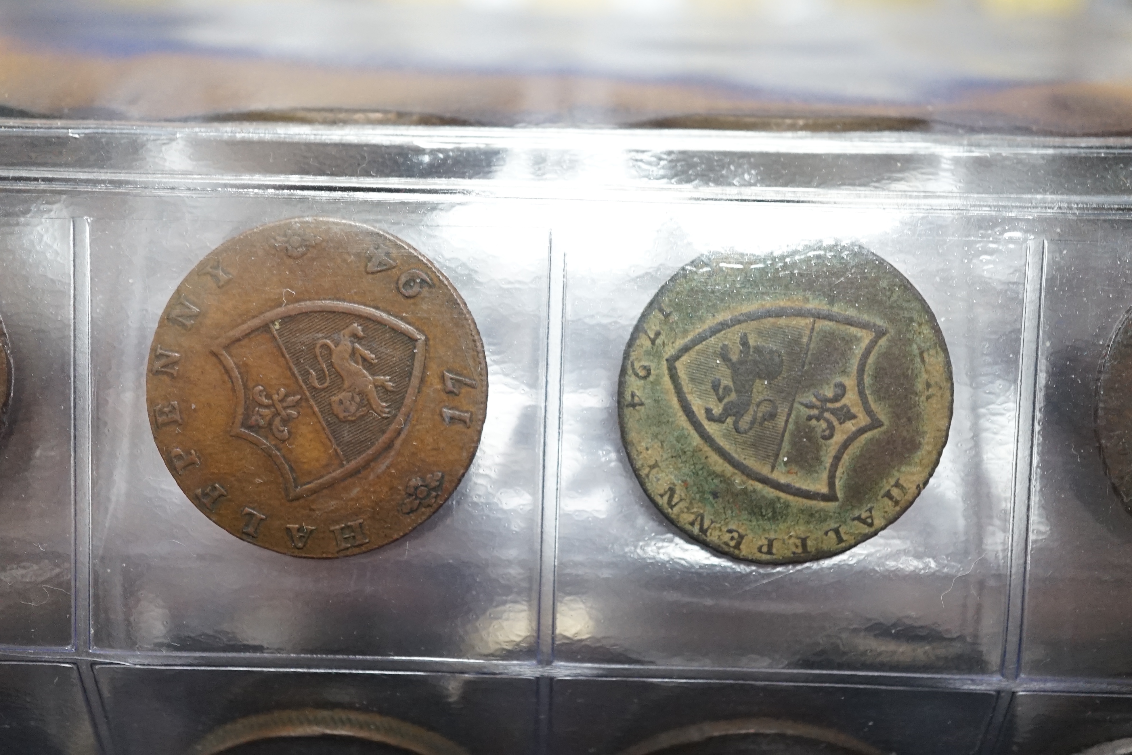 A large collection of halfpenny tokens and gaming tokens, 17th to early 20th century, in an album